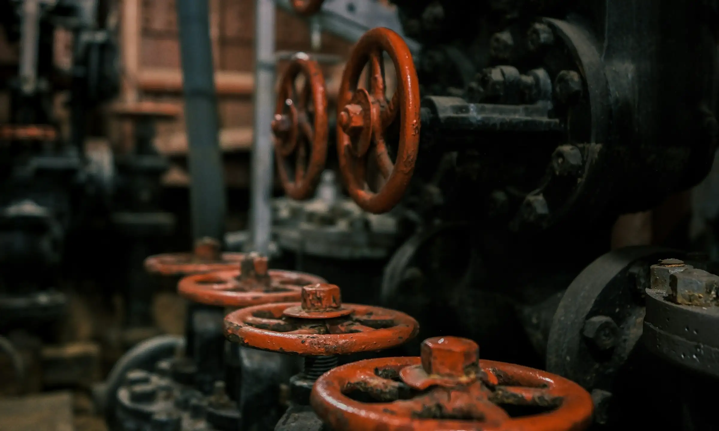 Red hand wheels on industrial pipework valves
